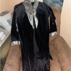 Woman’s bath robe , color black with flare around the wrist and neck